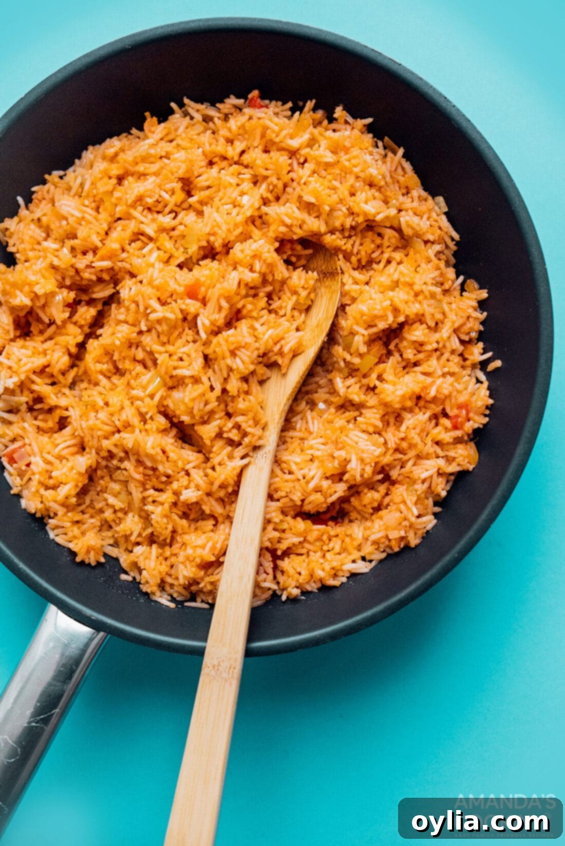 A large skillet filled with freshly cooked classic Spanish rice, showing its beautiful texture and color.