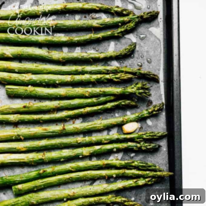 Sheet pan filled with perfectly roasted asparagus, ready to be served