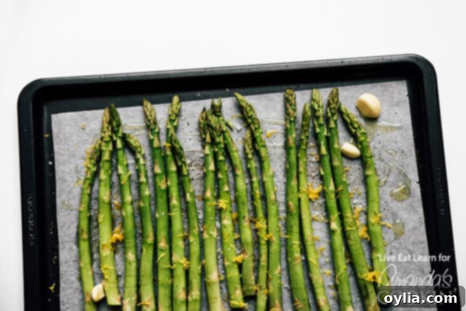 Close up of roasted asparagus spears beautifully topped with fresh lemon zest, ready to serve