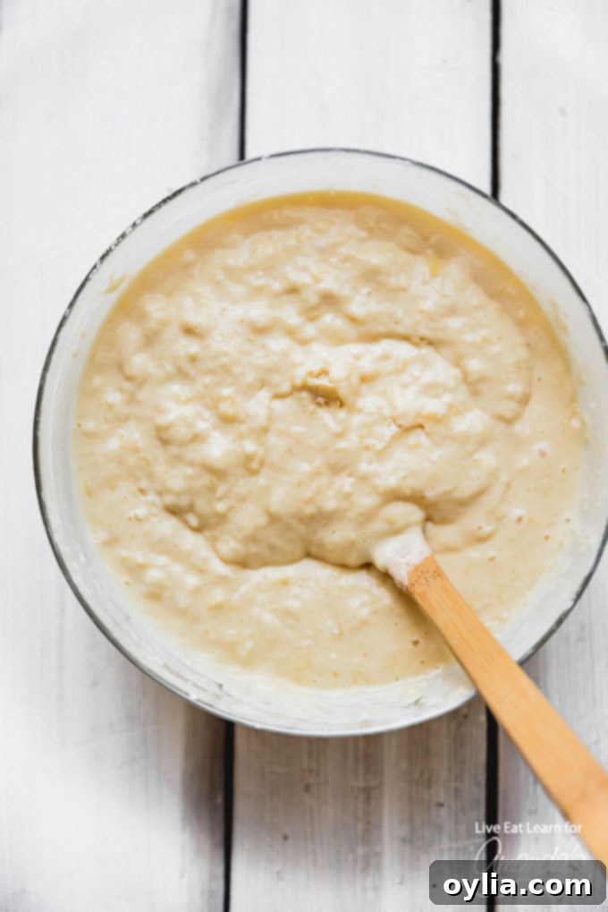 A close-up shot of dry ingredients for homemade buttermilk pancakes (flour, sugar, baking soda, salt) perfectly mixed in a large bowl.