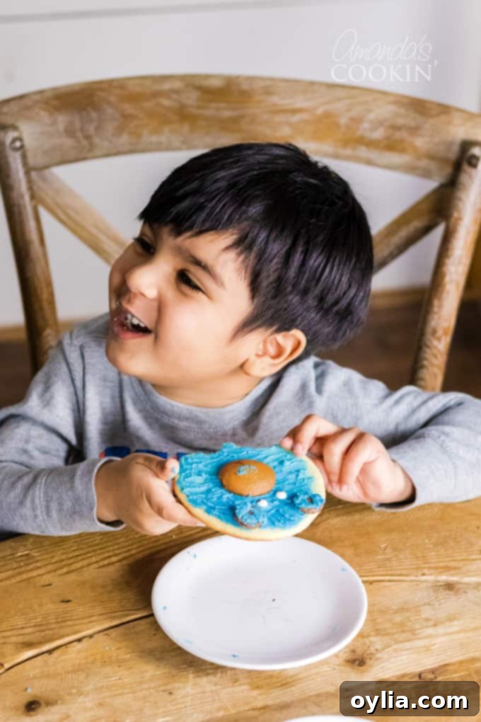 little boy eating bear cookie