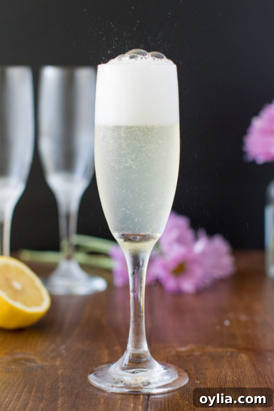 The Effervescence of a French 75 Cocktail Champagne fizzing and bubbling in a tall, elegant flute glass