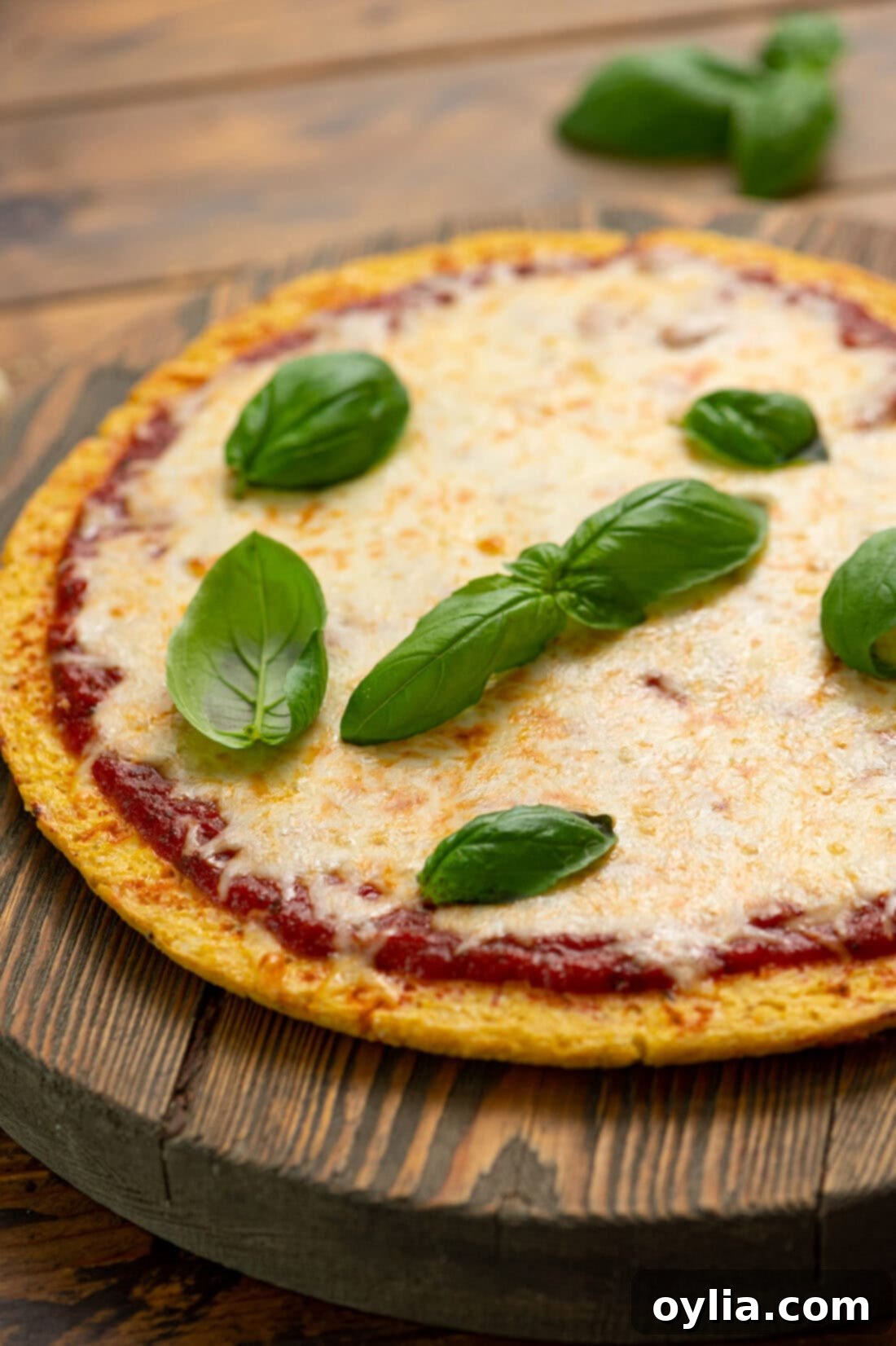 Close up photo of a perfectly baked golden brown Cauliflower Pizza Crust, displaying its crispy texture and delicious appearance, ready for toppings.