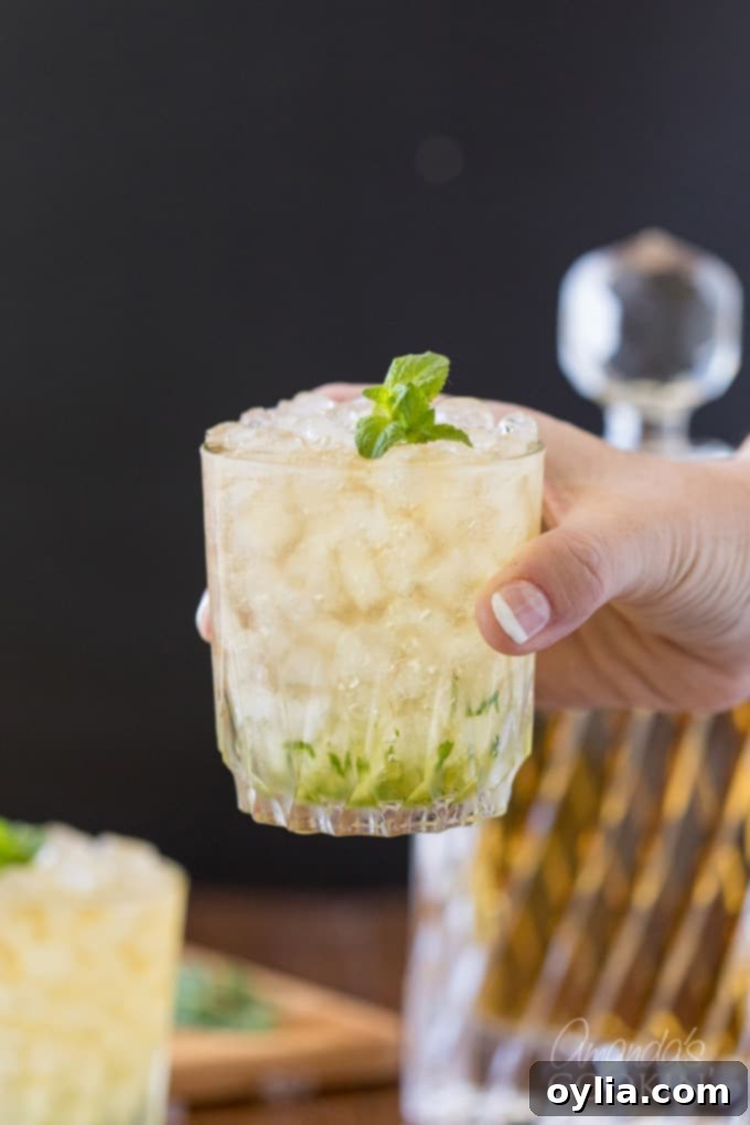 hand holding a glass of mint julep