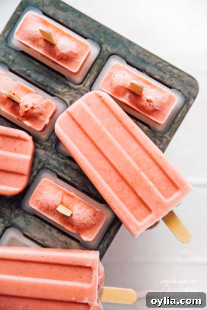 Creamy Strawberry Banana Popsicles in a popsicle mold, ready to be frozen.