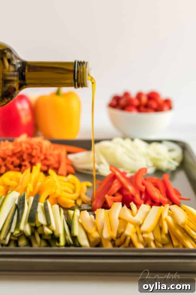 pouring olive oil onto fresh julienned vegetables on a pan