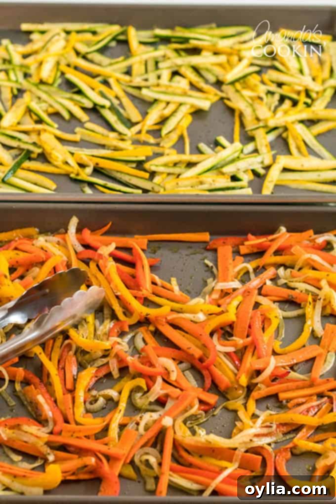 tongs picking up roasted vegetables off pan, perfectly cooked