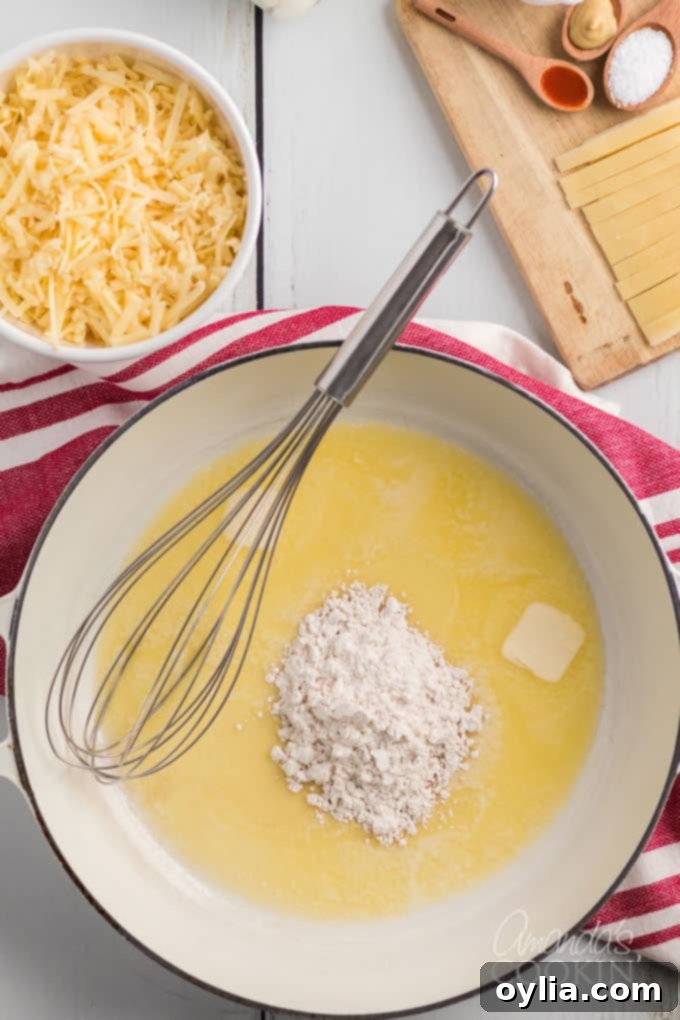 saucepan with melted butter, a whisk, and flour
