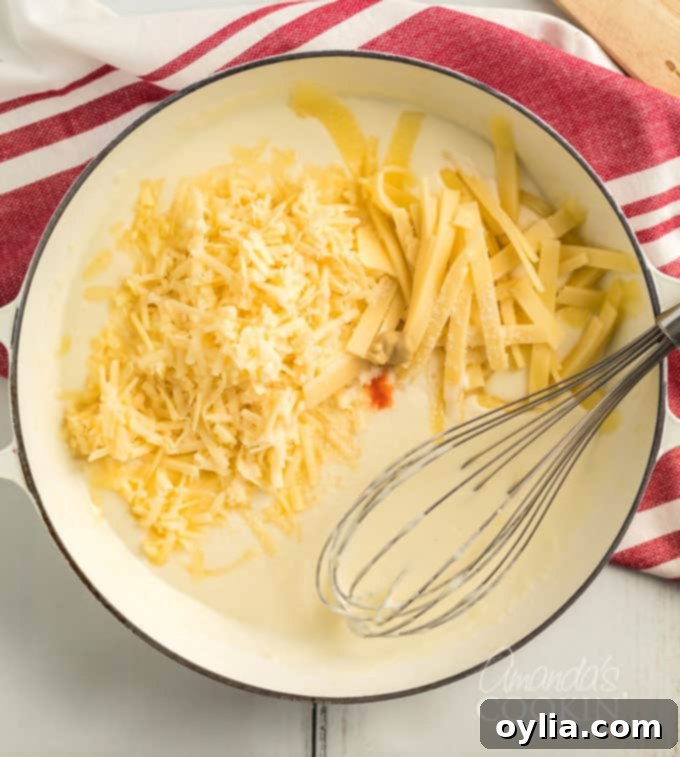 saucepan with a flour roux and shredded cheeses