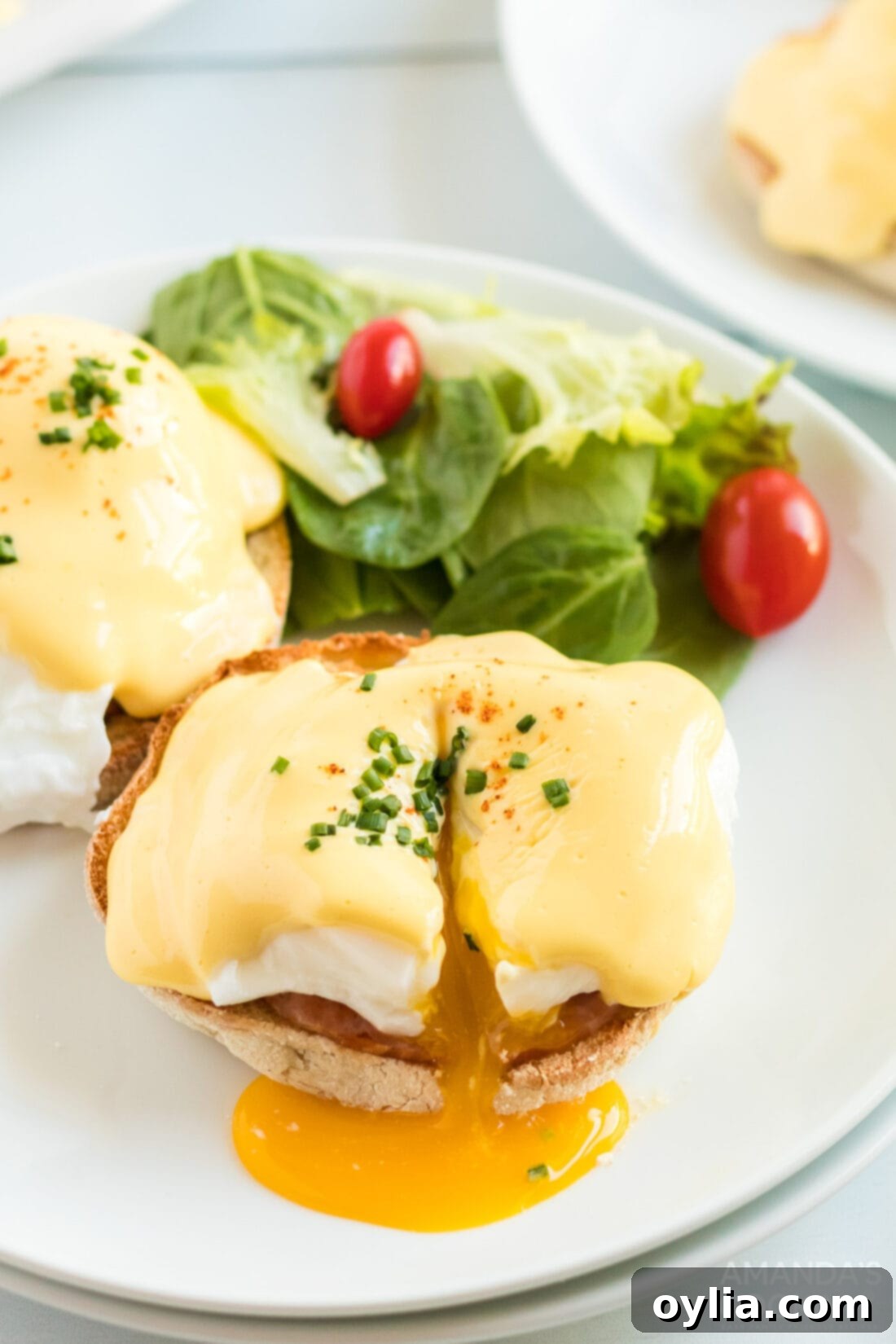 cut open eggs benedict on a plate