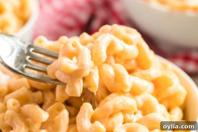 A fork lifting a delicious spoonful of quick Instant Pot mac and cheese