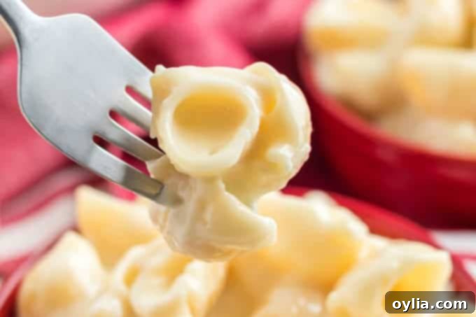 A fork showing creamy, authentic homemade Panera Bread copycat mac and cheese
