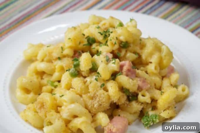 Hearty mac and cheese casserole baked with ham and peas