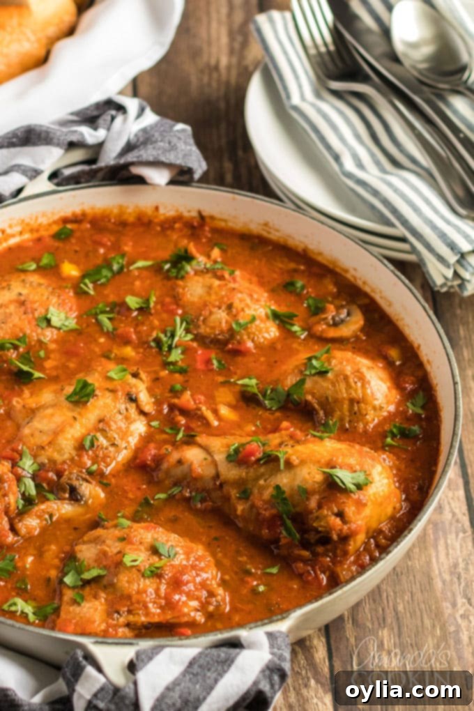 Finished Chicken Cacciatore stew bubbling gently in a large skillet, ready to be served.
