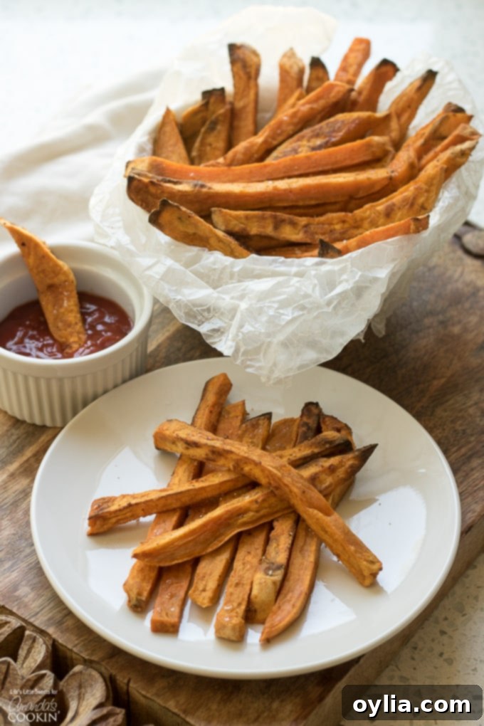 A vibrant bowl of crispy baked sweet potato fries, seasoned to perfection.