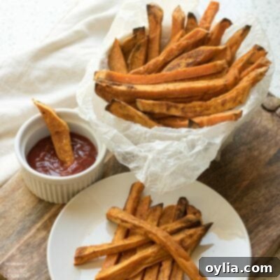 A bowl of perfectly golden and crispy baked sweet potato fries.