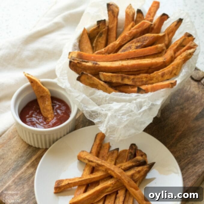Plated crispy sweet potato fries with a side of ketchup, ready to be enjoyed.