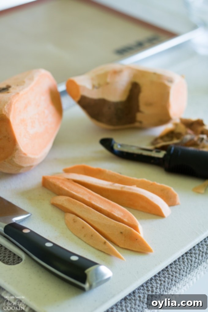 Peeled and uniformly cut sweet potato sticks, ready for seasoning.