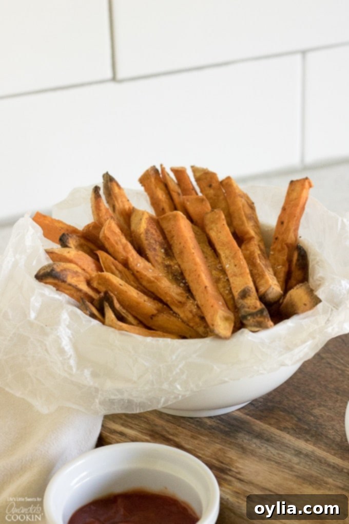 A close-up shot of sweet potato fries in a bowl, showing their texture.