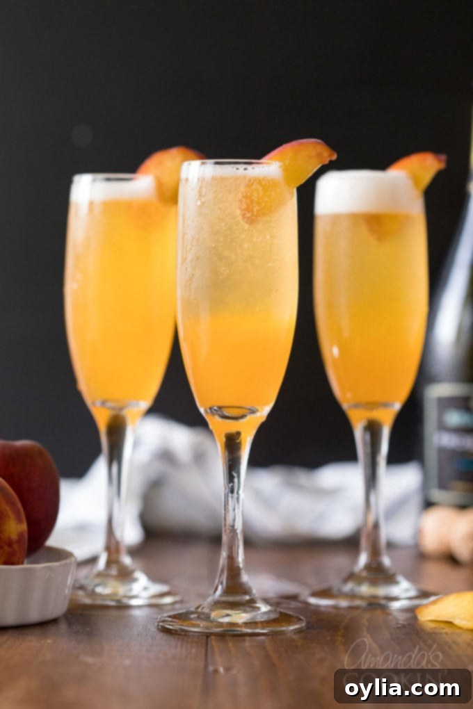 Two sparkling Bellini cocktails in champagne flutes garnished with fresh peach slices, ready for a summer brunch.