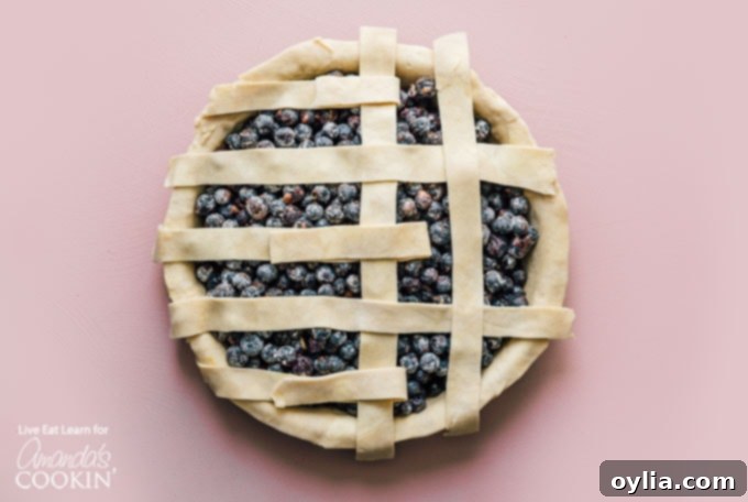 Blueberry Pie is a timeless classic. This recipe will show you how to make the perfect blueberry pie for your next party or get together. creating lattice design with dough