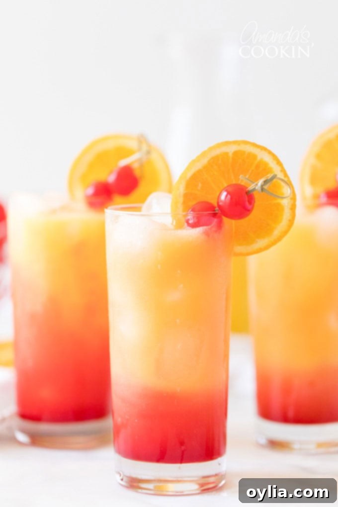 3 glasses of Tequila Sunrise drinks, showcasing the vibrant layered colors