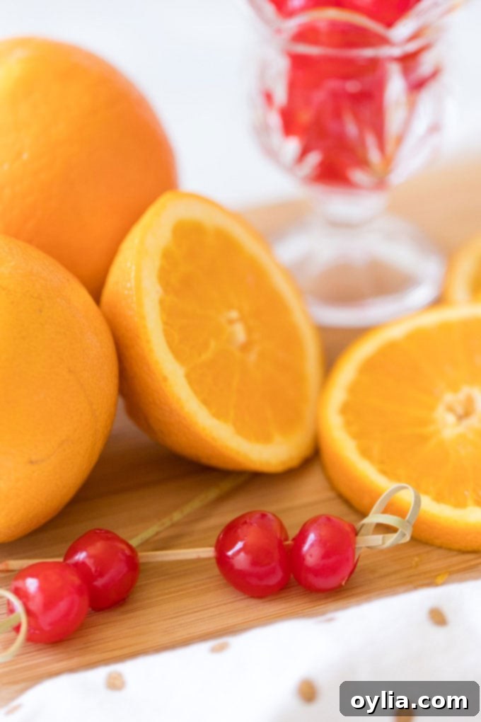 maraschino cherries skewered on toothpicks with sliced oranges, ready for garnish