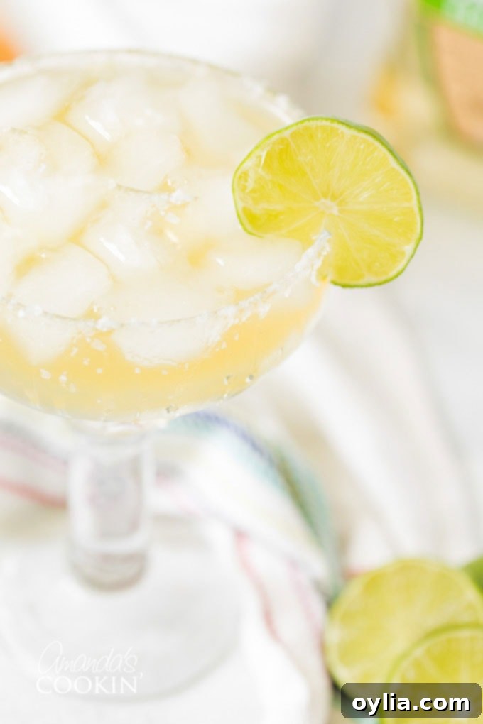 CLOSE UP OF MARGARITA ON THE ROCKS with a lime wedge garnish