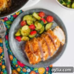 spicy oven fried chicken on a plate with side salad