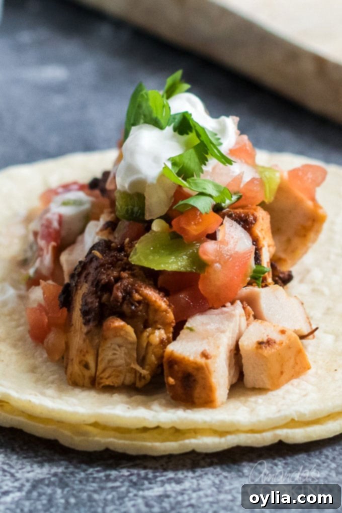 close up on chicken taco ingredients on corn tortilla