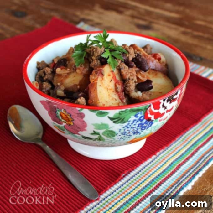 Delicious Slow Cooker Cowboy Casserole served in a bowl with a spoon, ready to eat.