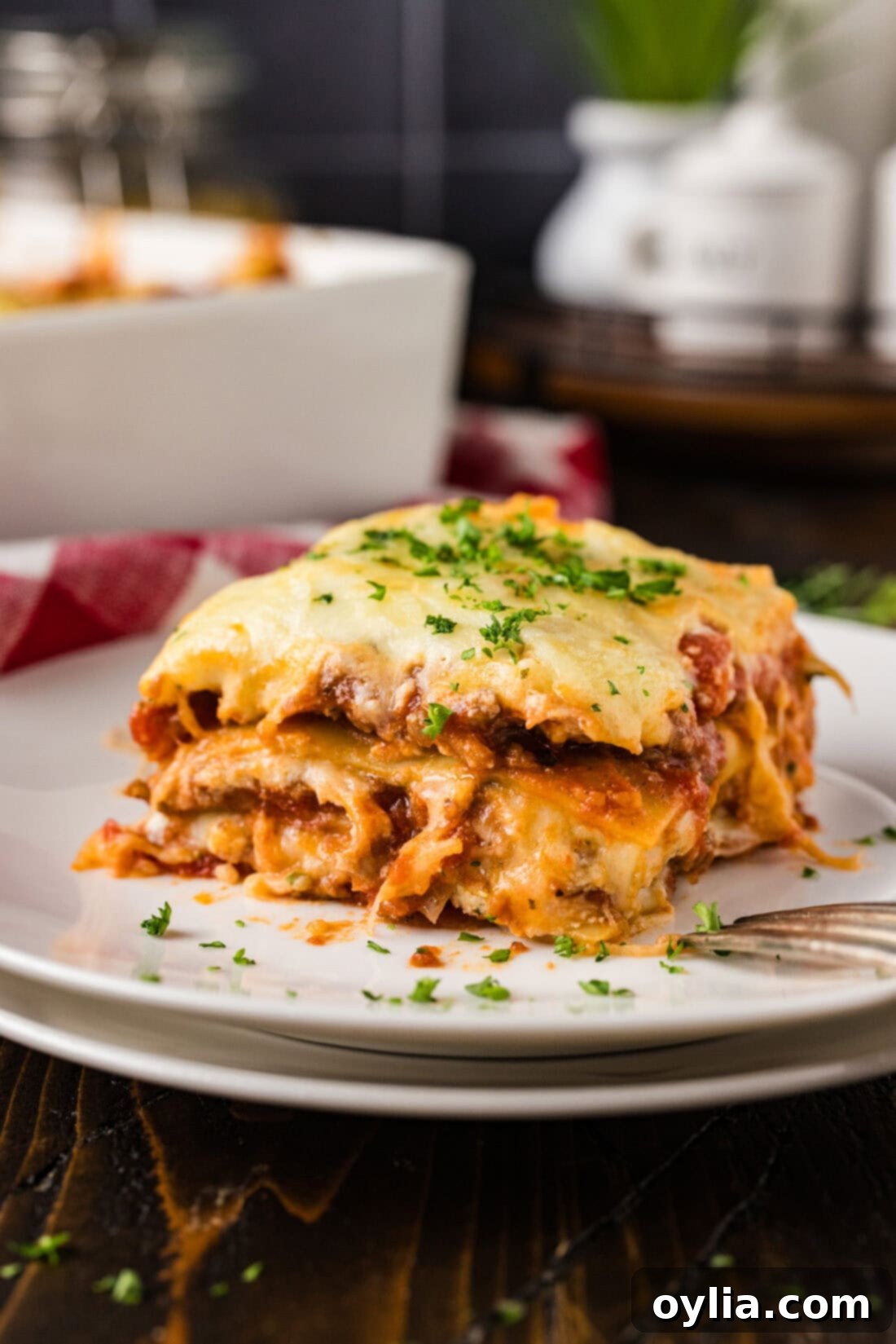 Perfect slice of Italian Lasagna on a white plate, ready to be enjoyed