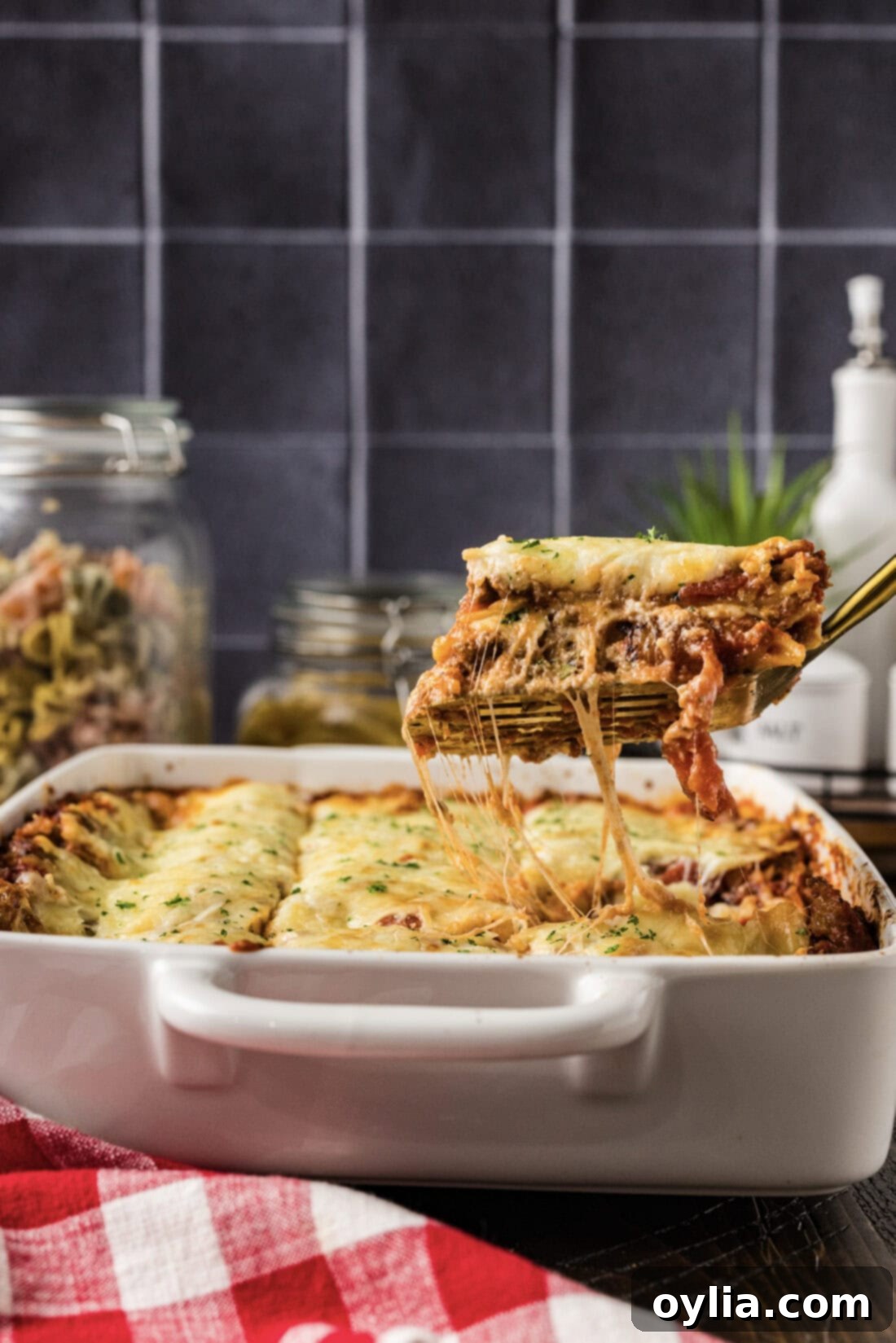 Spatula lifting up a perfectly baked piece of Italian Lasagna from the pan