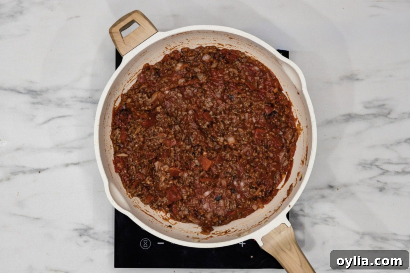 Lasagna meat sauce mixture simmering in a skillet