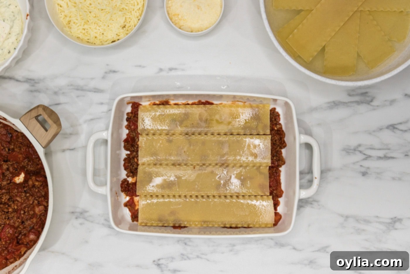 Soaked lasagna noodles placed over top of meat mixture in a casserole dish