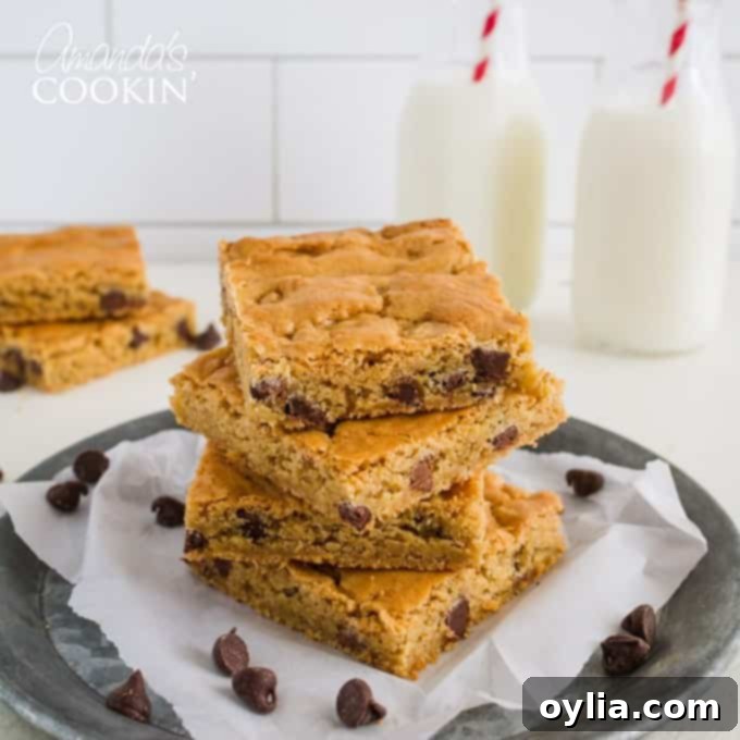 Chewy Chocolate Chip Blondies 5 A stack of perfectly baked, soft and chewy chocolate chip blondies on a cooling rack.