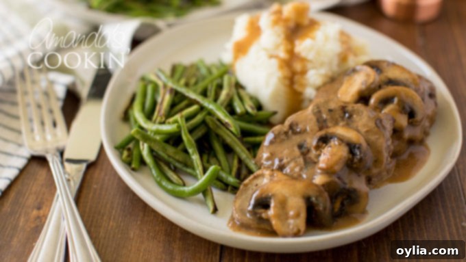 Salisbury steaks on a dinner plate with gravy, ready to eat