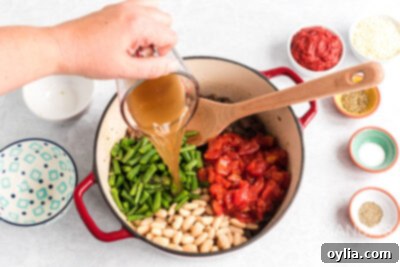 pouring vegetable broth into pot