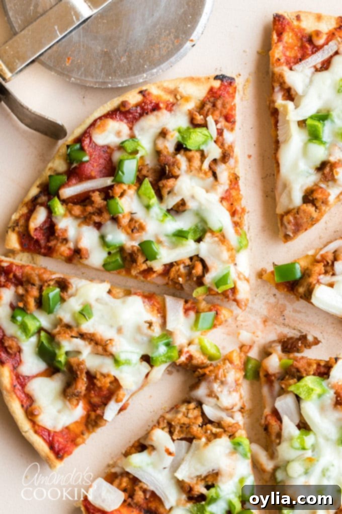 slices of homemade pizza with sausage and green pepper
