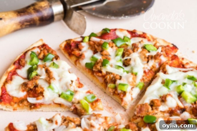 pizza sliced with a pizza wheel in background
