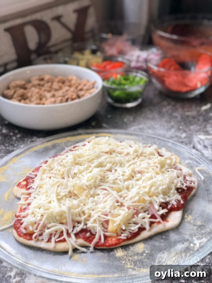 Assembling a homemade pizza with fresh sauce, cheese, and toppings.