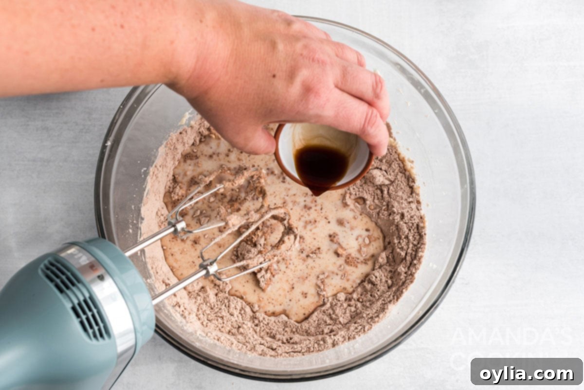 adding vanilla to the mixer bowl