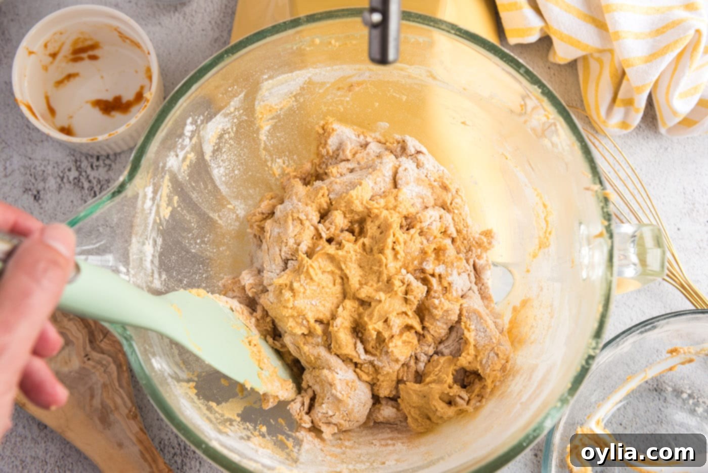 Pumpkin muffin dough forming in a mixer bowl