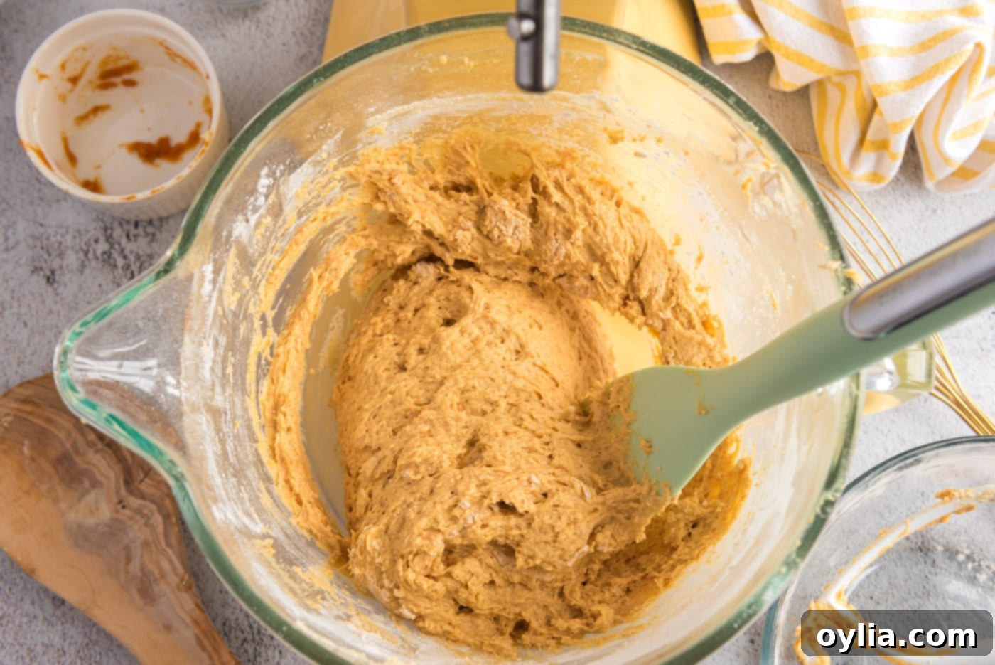 Smooth pumpkin muffin dough in the mixer bowl after combining wet and dry