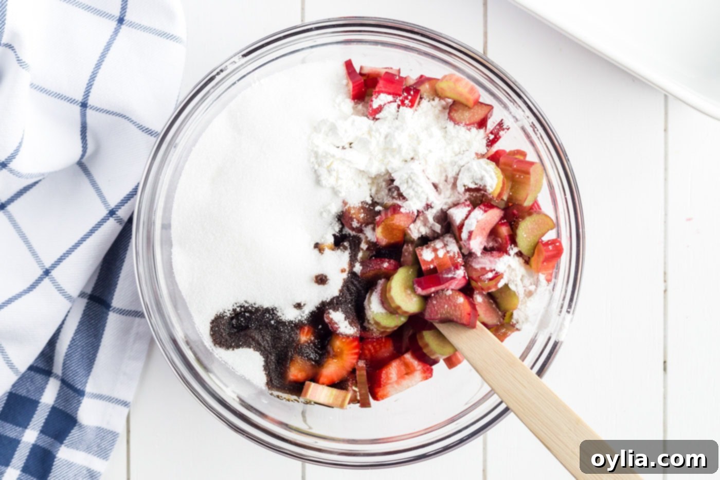 Bowl of rhubarb, strawberries, and blueberries, sugar, cornstarch and balsamic vinegar