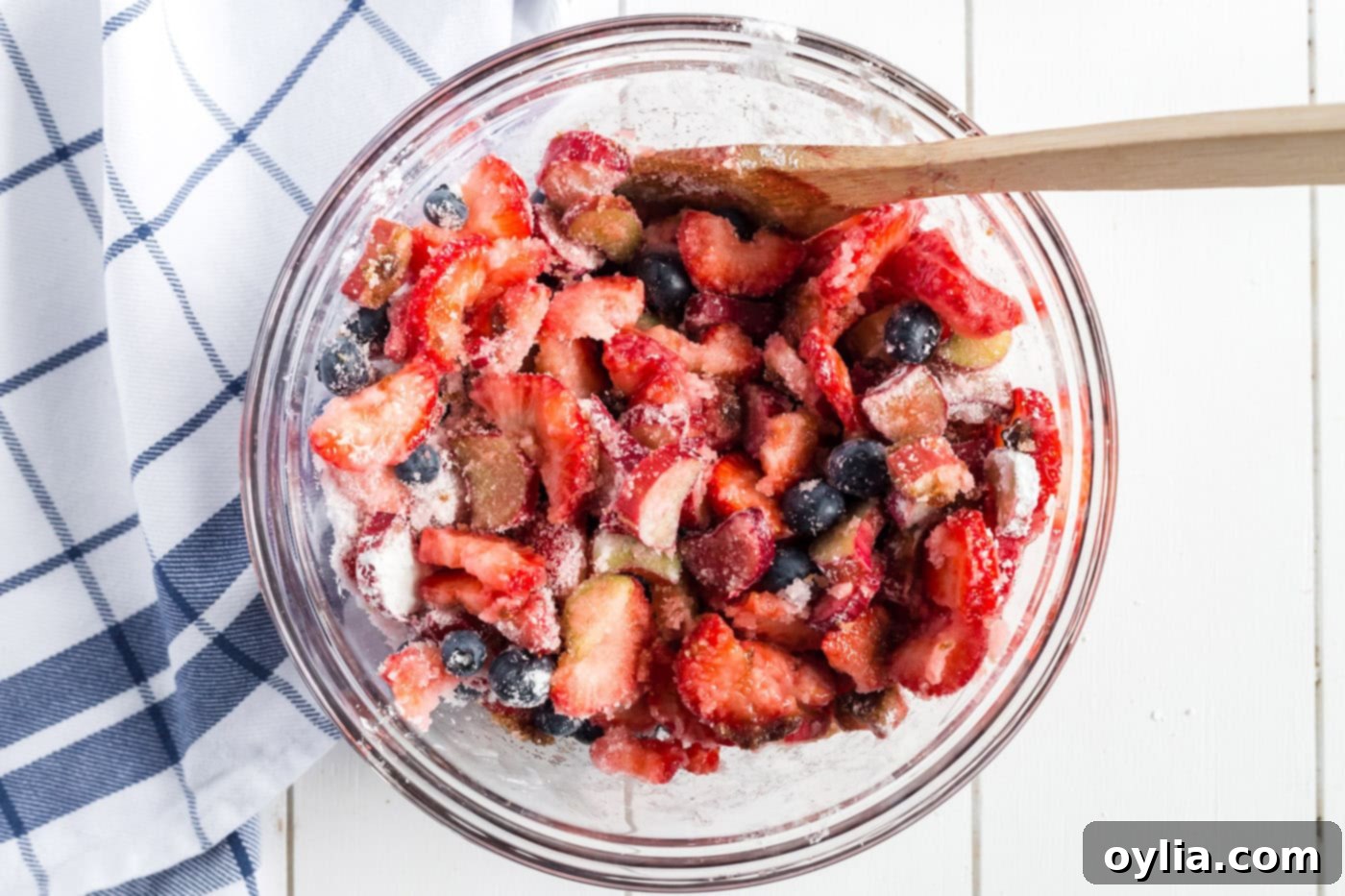 Bowl of rhubarb, strawberries, and blueberries, sugar, cornstarch and balsamic vinegar