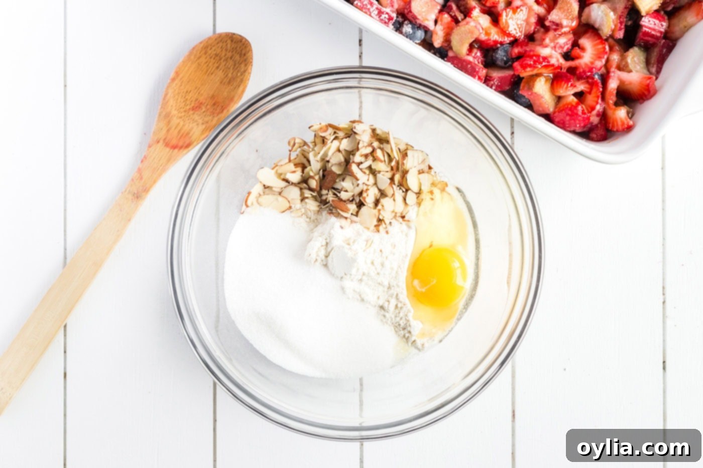 Flour, sugar, salt, sliced almonds and egg in a bowl