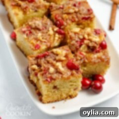 Overhead view of several square slices of homemade cranberry coffee cake with a generous streusel topping