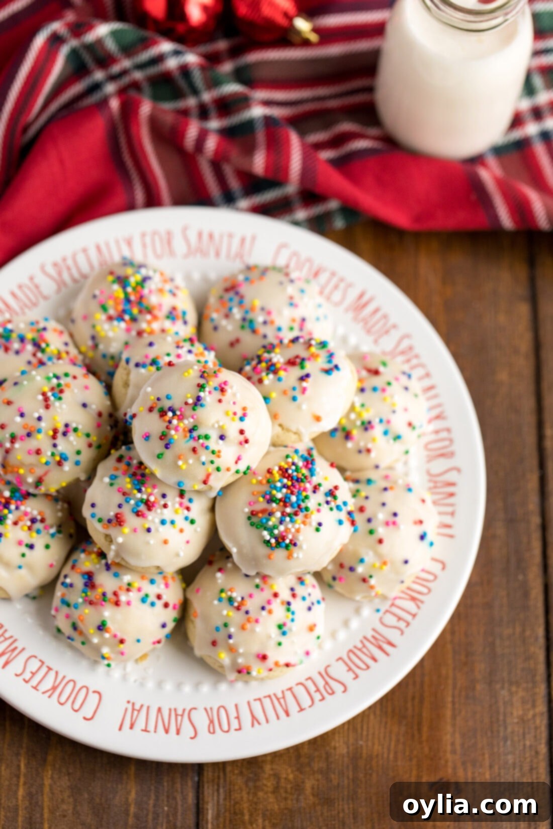 Italian Anise Cookies 3 A beautifully arranged plate filled with freshly baked and glazed Italian Anisette Cookies, adorned with festive sprinkles, ready to be served and enjoyed by guests.
