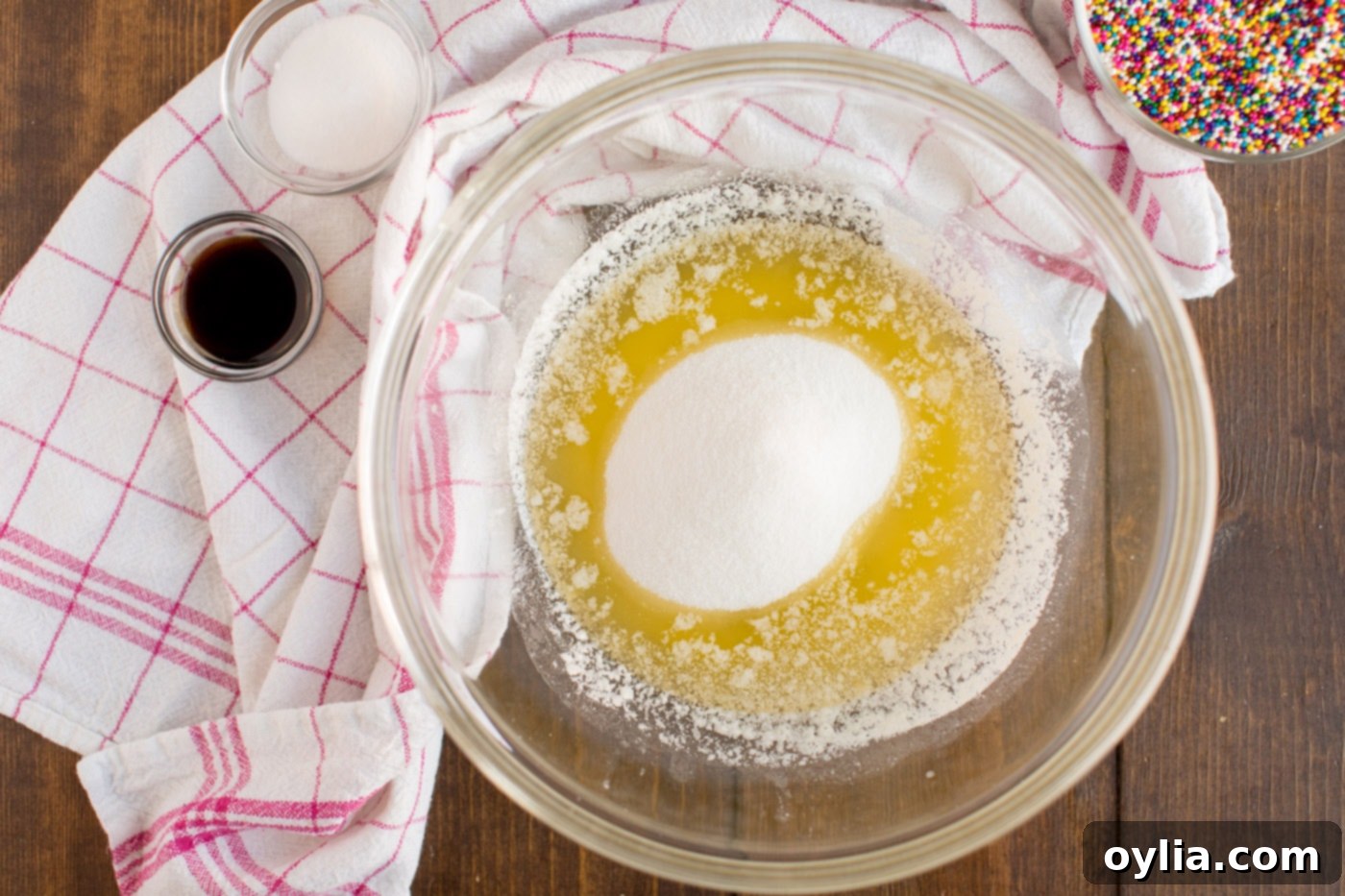 Melted butter and shortening combined with granulated sugar in a mixing bowl, showcasing a smooth, creamy texture, ready for the next baking steps.